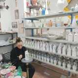 Da questo ambiente accediamo al capannone industriale vero e proprio, in cui ogni angolo � destinato a uno specifico passaggio della lavorazione. In particolare la decorazione, che qui usufruisce di una silenziosa stanzetta apposita. Proprio in questo piccolo locale troviamo infatti una giovane alle prese con un�oliera: con i sapienti tocchi del suo pennello la sta arricchendo con motivi vegetali